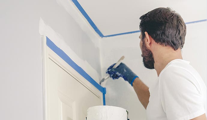 worker painting in apartment