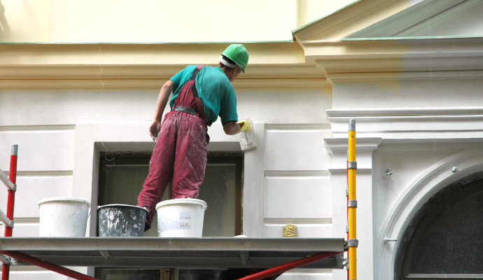worker painting a hotel