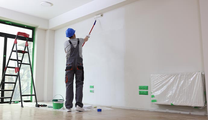 worker painting commercial building's interior