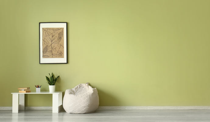 a minimalist interior space with pastel green painted wall