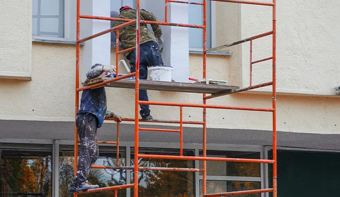 professional painters working on scaffolding